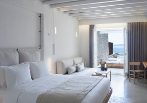 Schlafzimmer und Terrasse mit Blick aufs Meer einer Deluxe Coast Suite im Bill & Coo Leading Hotels of the World Mykonos Griechenland
