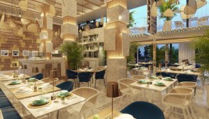 modern gestaltetes restaurant mit hohen decken und zweiertischen im raum verteilt an den säulen im raum runde und eckige formen mit hintergrundlicht
