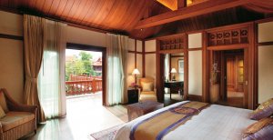 luxuriöses schlafzimmer mit ausblick auf den garten im dhara dhevi in chiang mai thailand